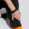 Pulseira com logótipo em moeda «Preto» 656450-TZ10Z-1268